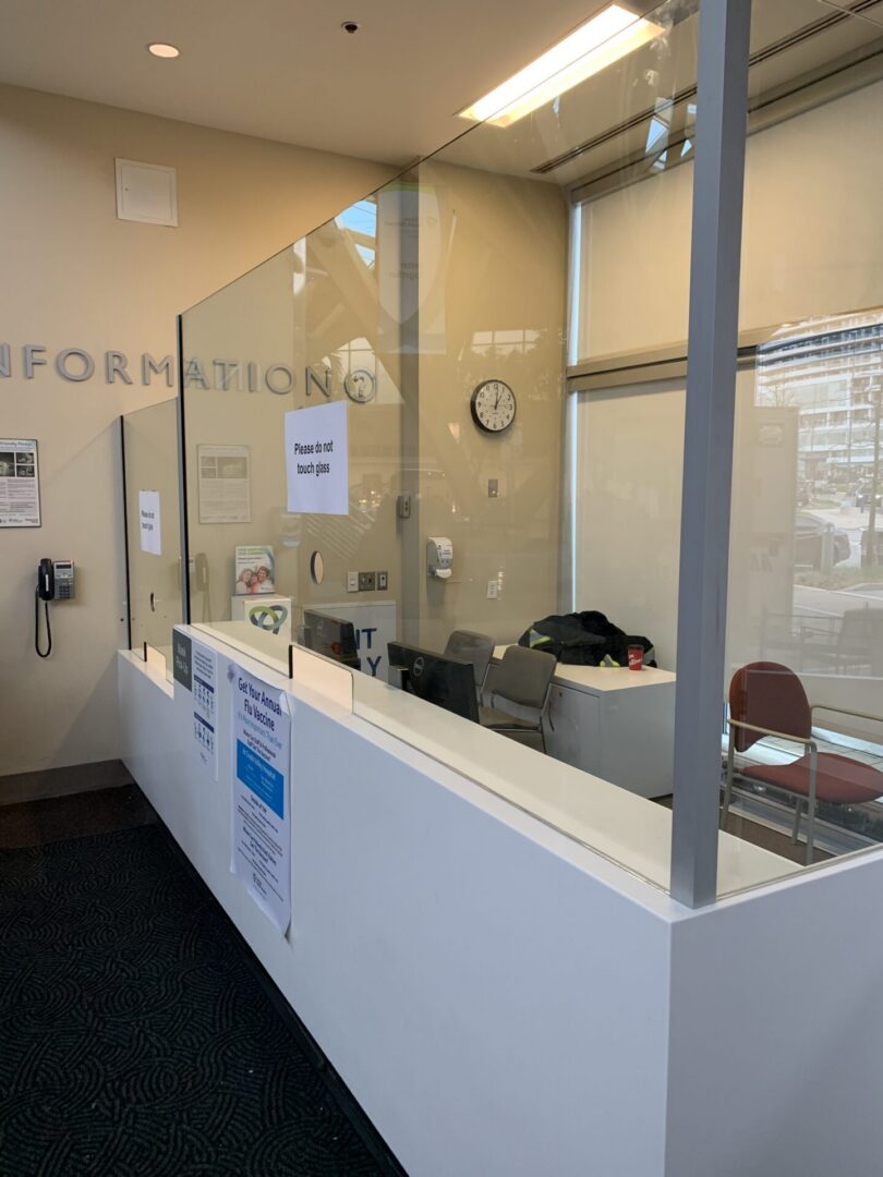 Information desk with clear protective barrier